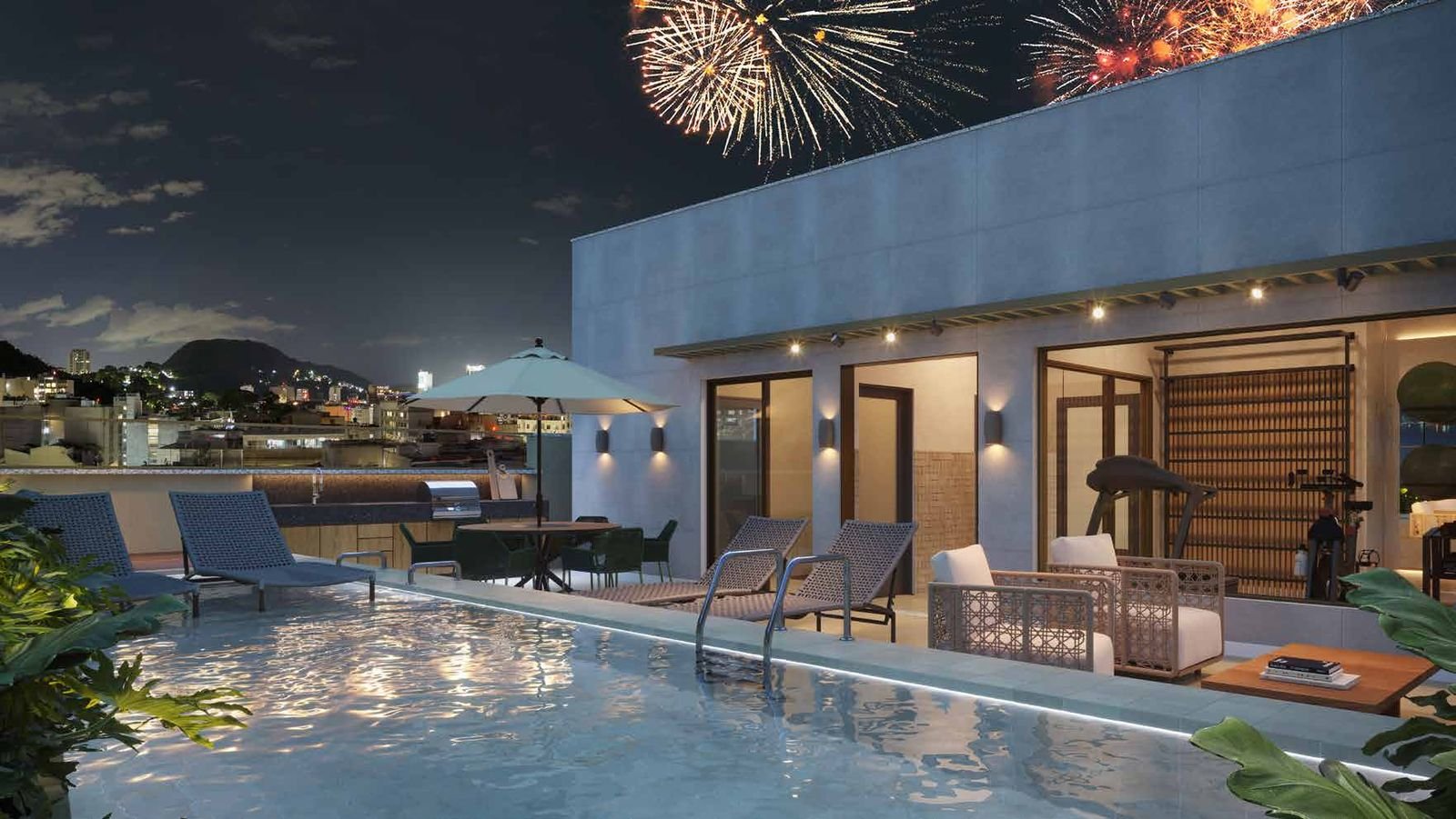 Rooftop do Be.in.Rio Tonelero à noite, com piscina e fogos de Copacabana