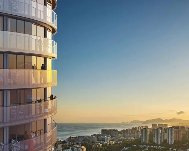 Torre cilíndrica do Niemeyer 360 Residences ao pôr do sol na Barra da Tijuca